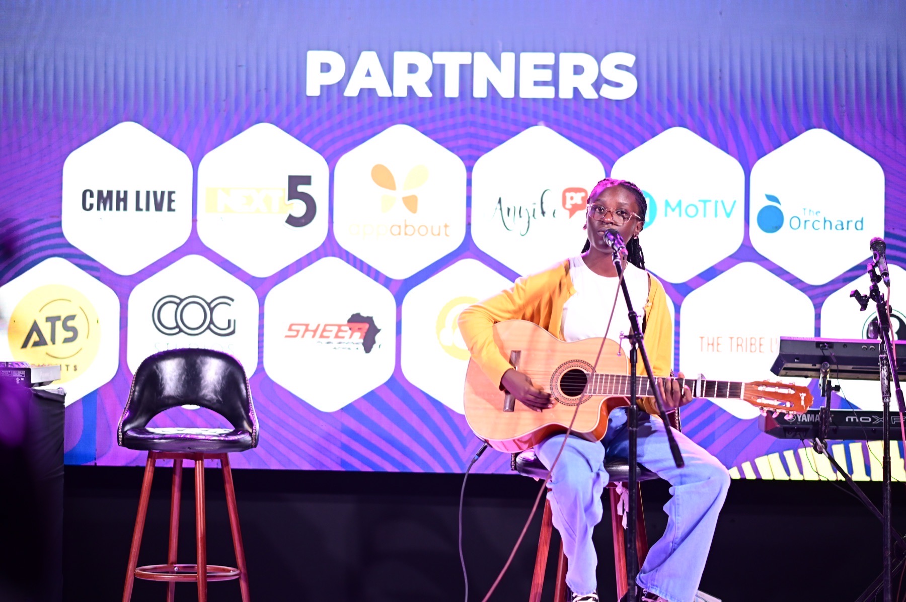 Acoustic guitarist performing during a partner showcase