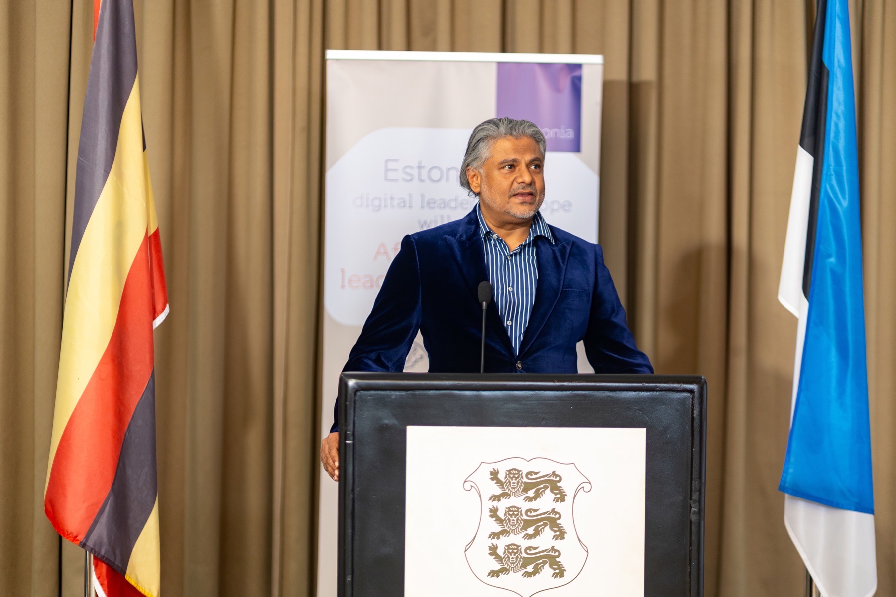 International conference speaker addressing delegates from a podium