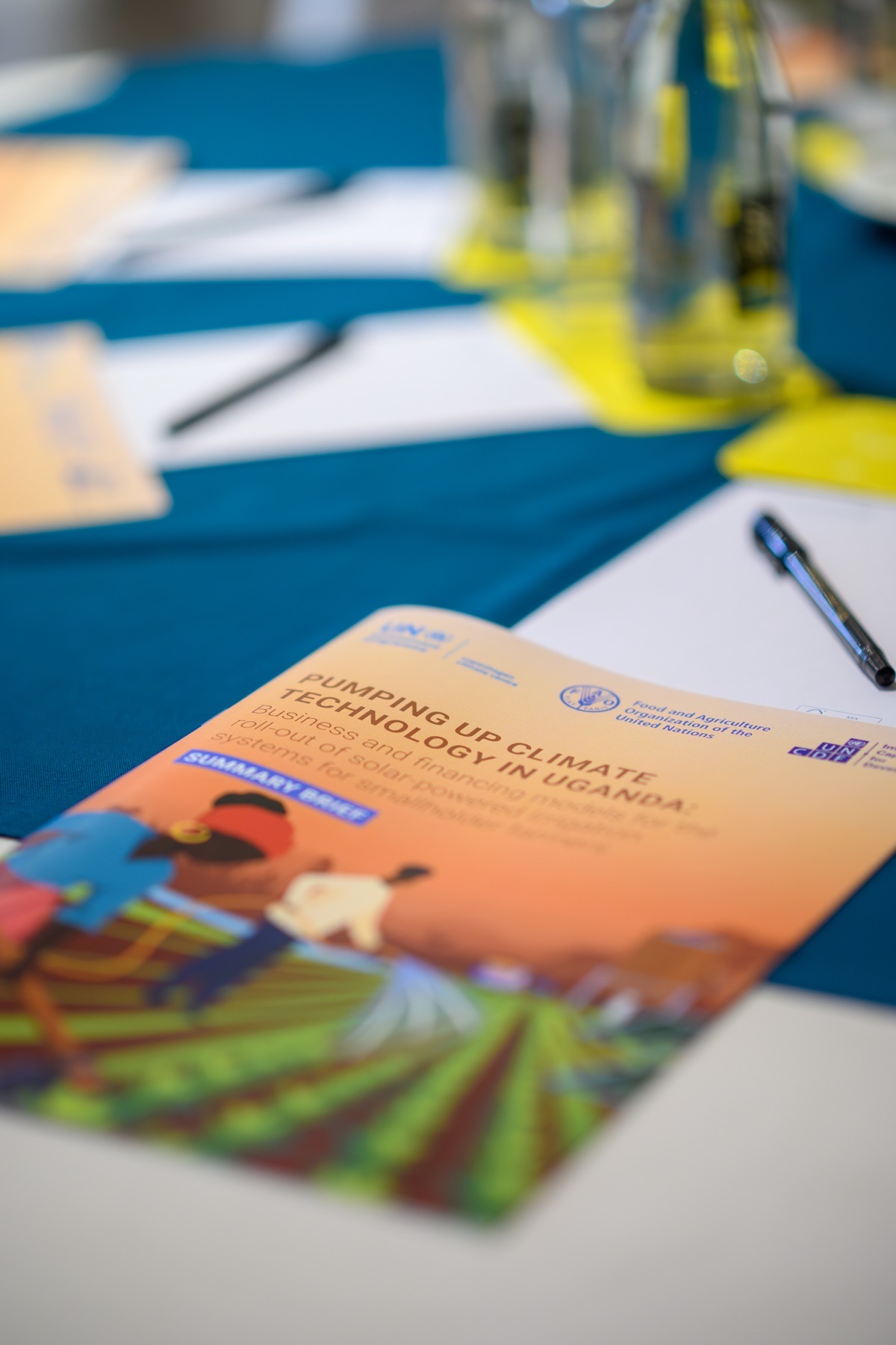 Climate technology conference brochure arranged at a delegate table