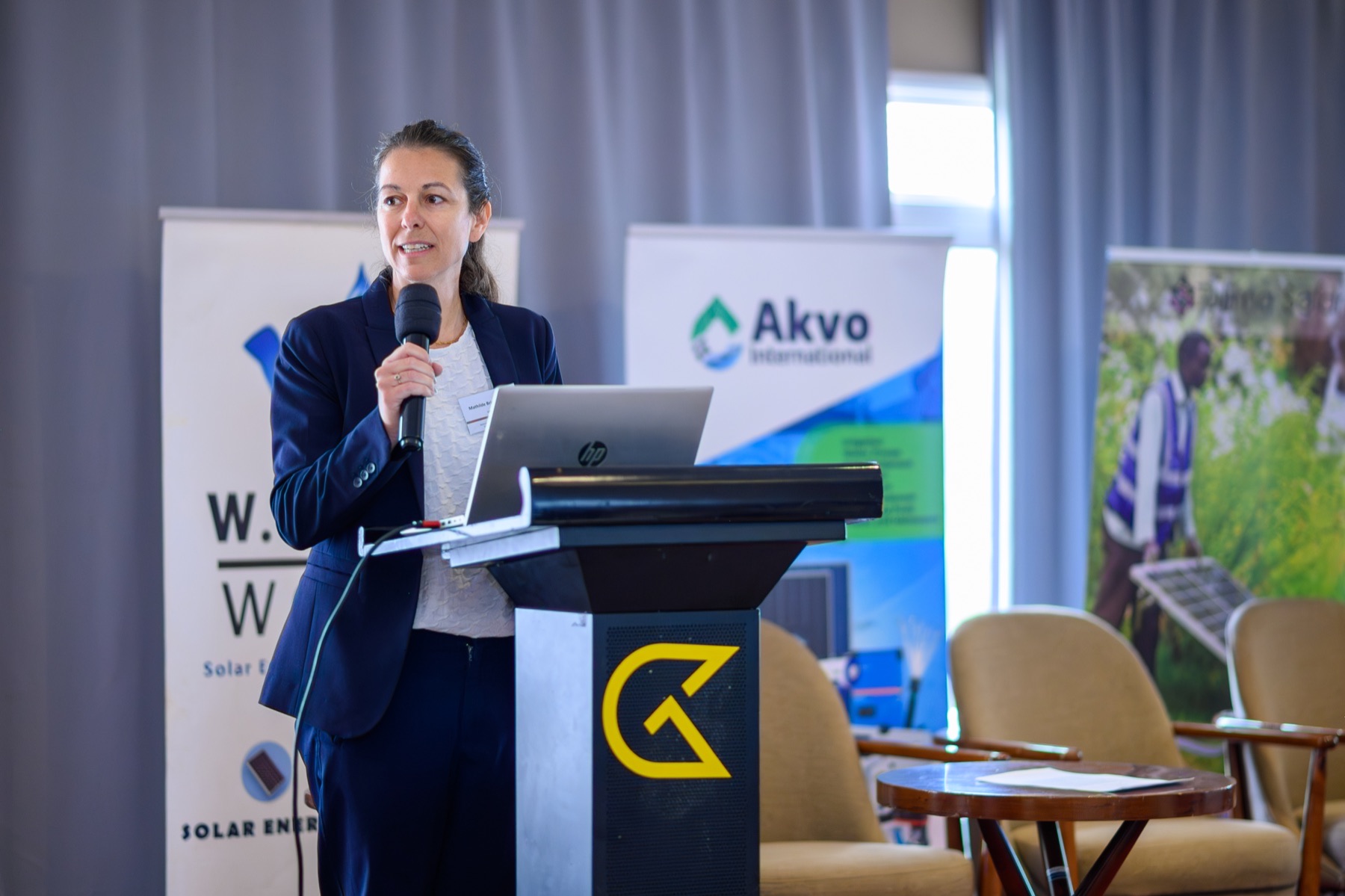Conference speaker presenting from an Akvo-branded podium