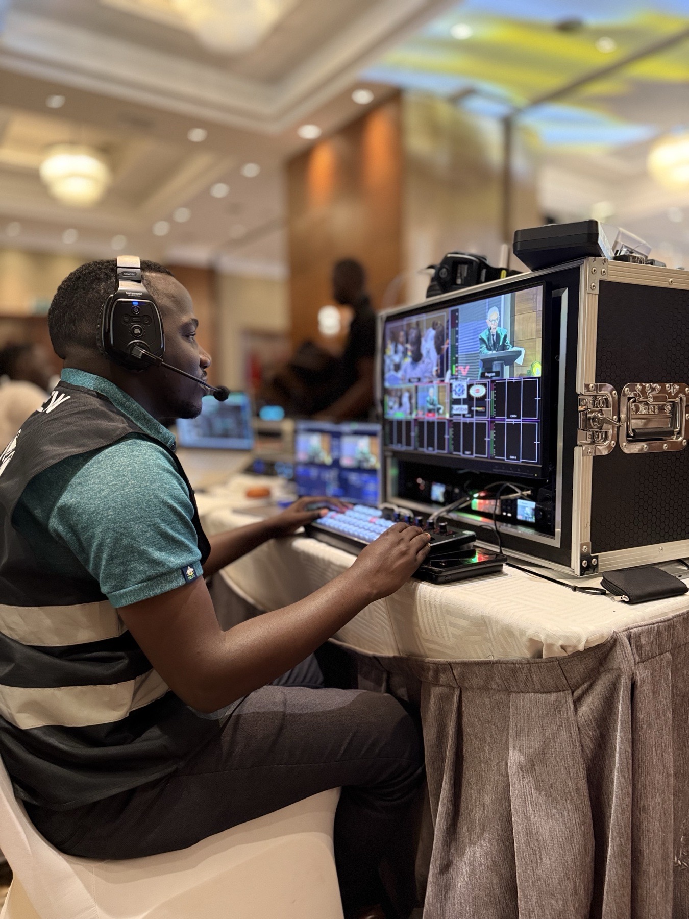 Live production technician operating a multi-camera video switcher