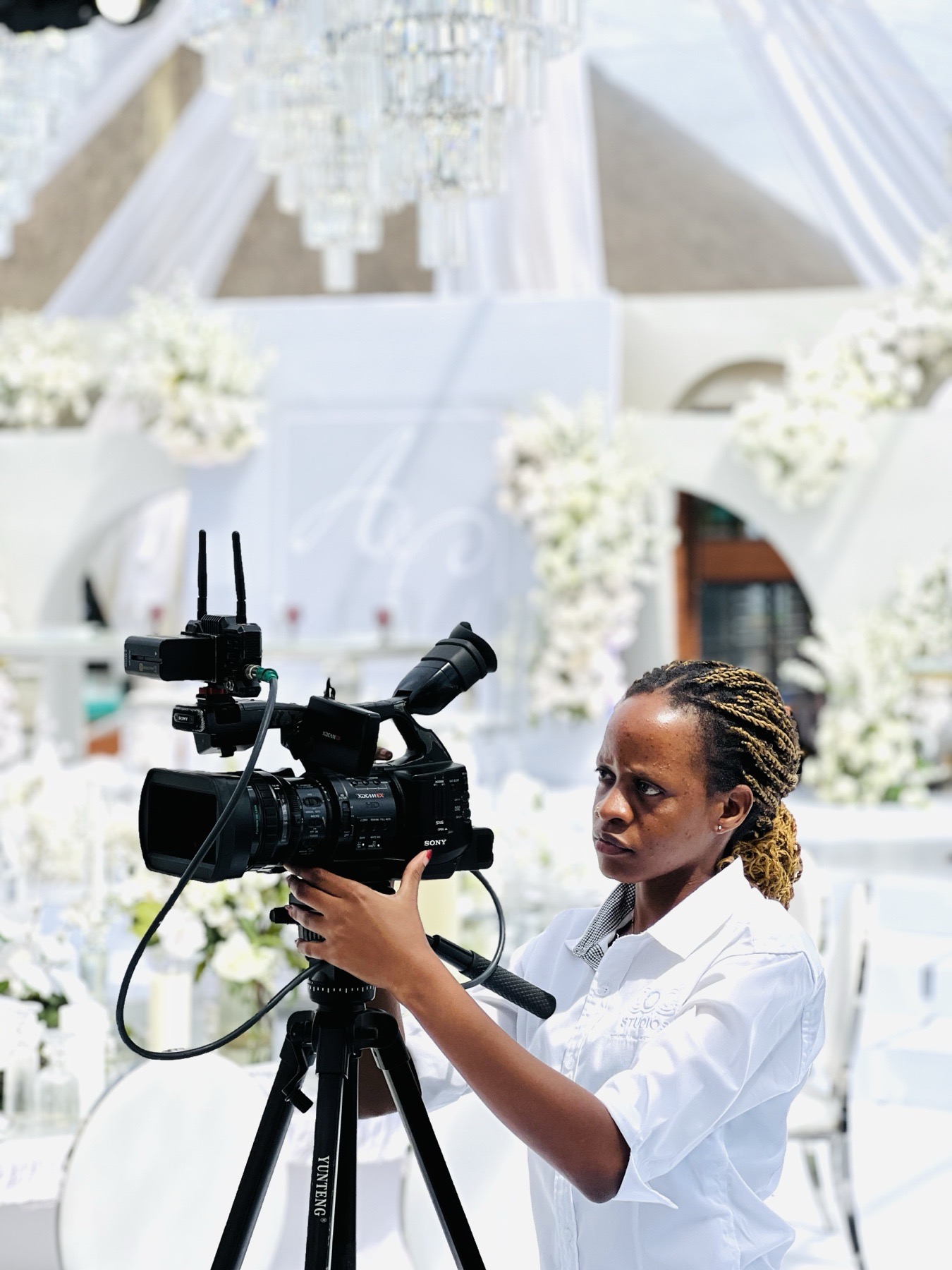 COG Studios camera operator preparing a broadcast camera at an event venue