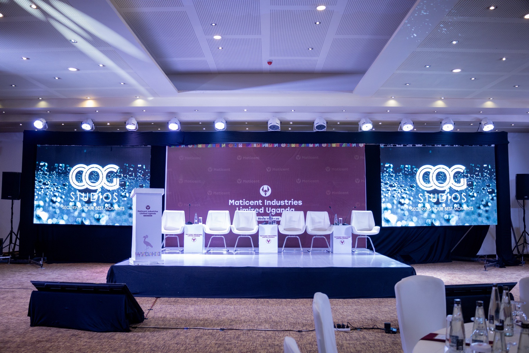 Professionally produced conference stage with screens and seating