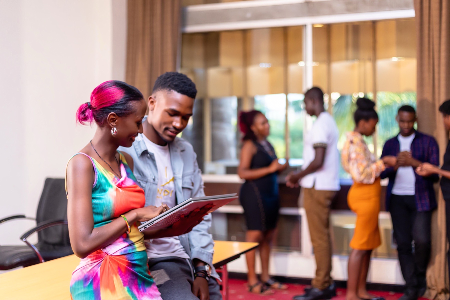 Young professionals reviewing a laptop during an event