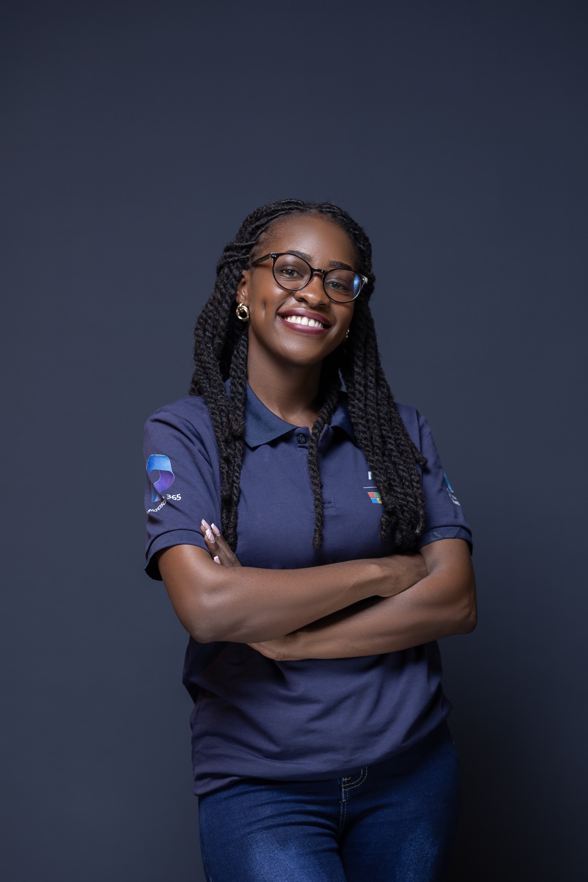 Woman wearing glasses and a branded polo with her arms crossed