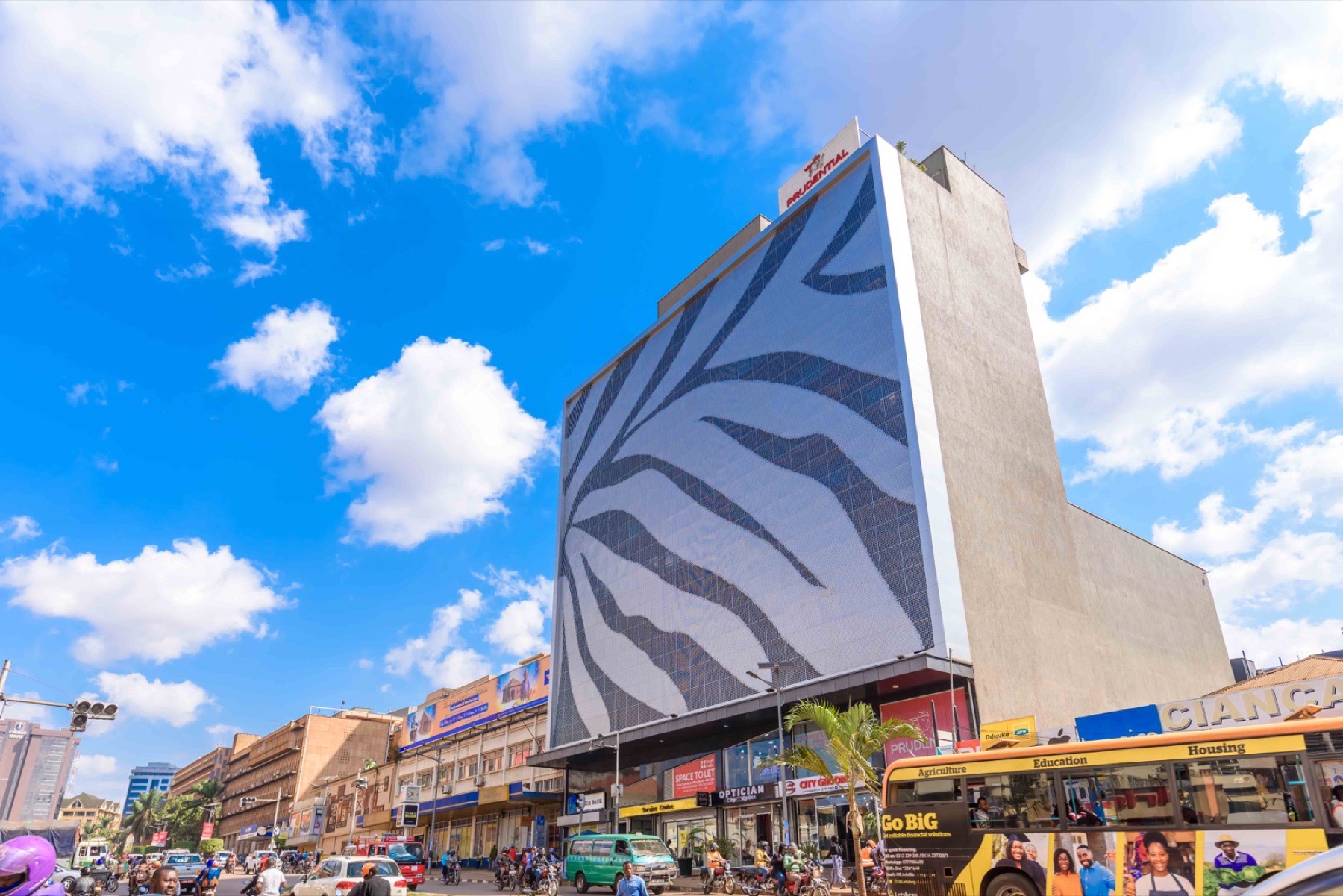 Zebra Plaza tower photographed beneath a blue Kampala sky