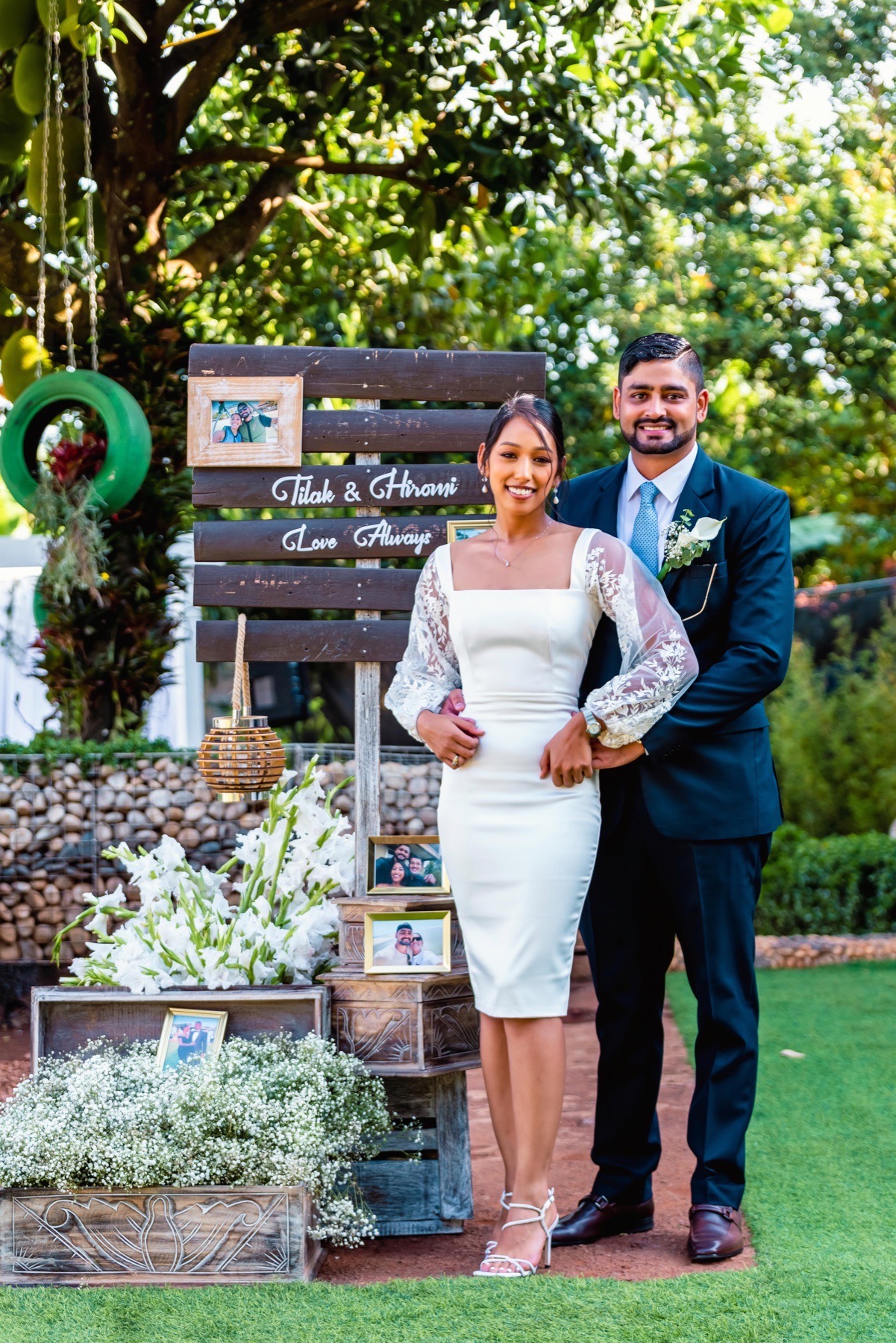 Wedding couple standing beside a personalised floral display