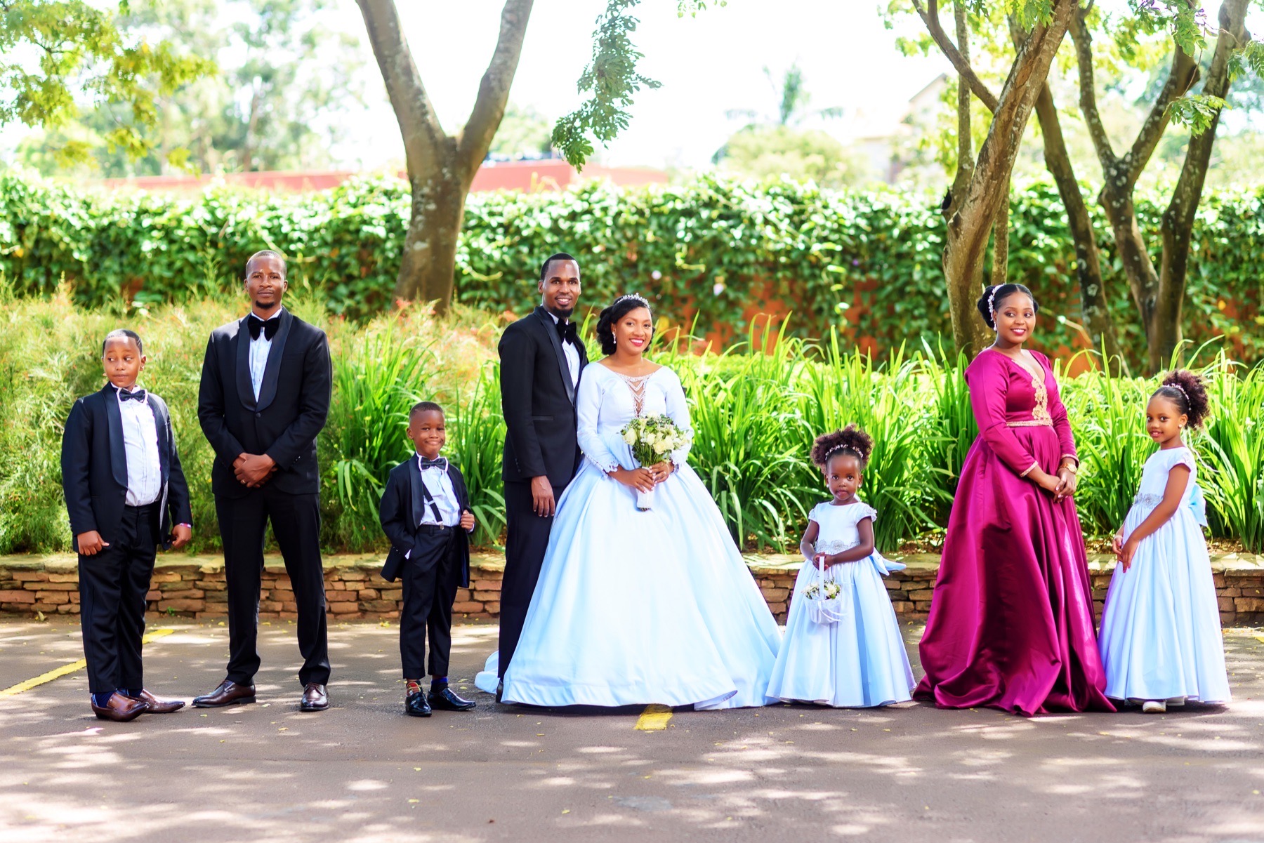 Wedding couple and family posed for an outdoor group portrait