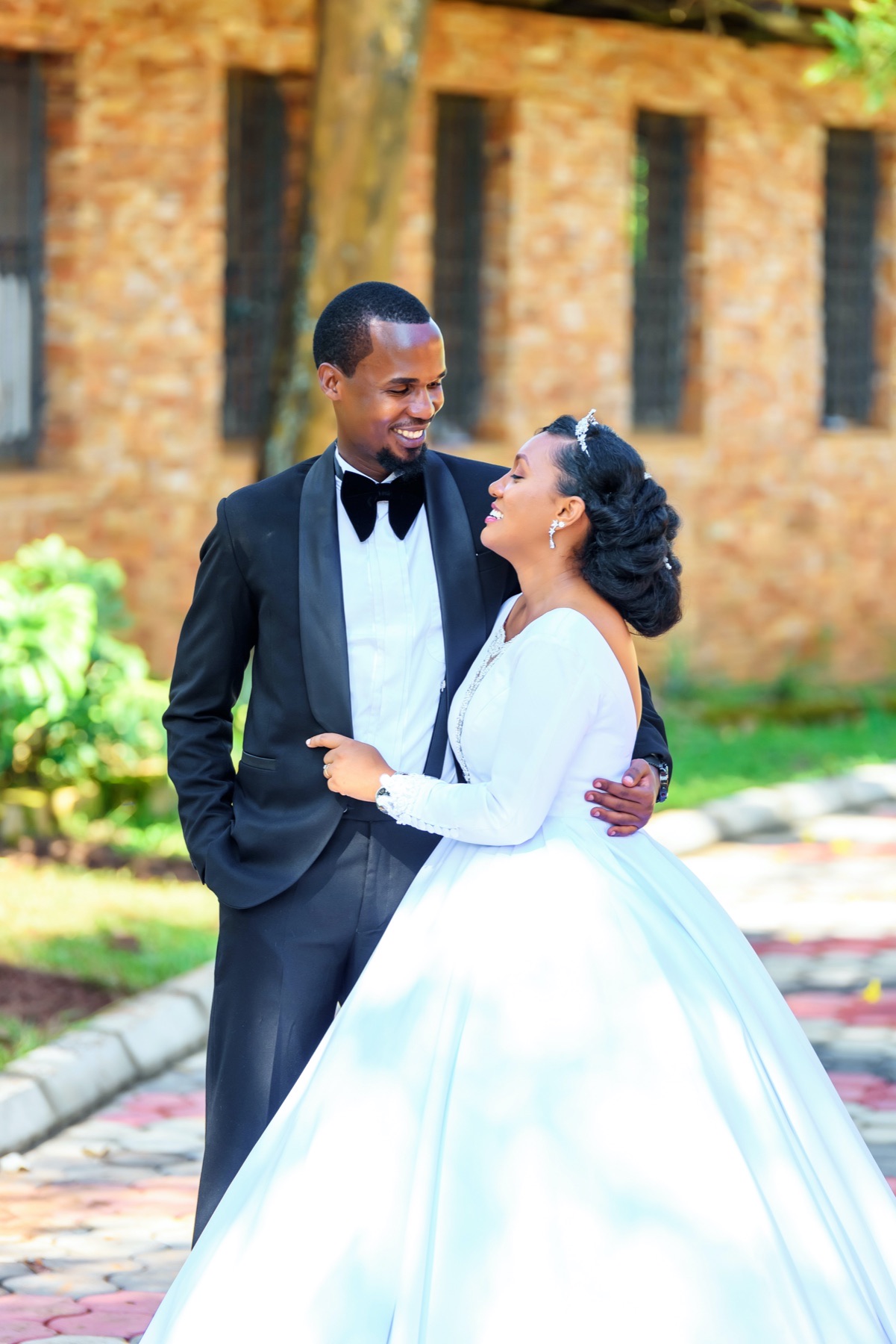 Bride and groom sharing a joyful look outdoors